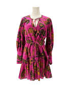 Pink dress with a pattern on a mannequin against a white background