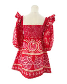 Red patterned dress on a mannequin against a white background