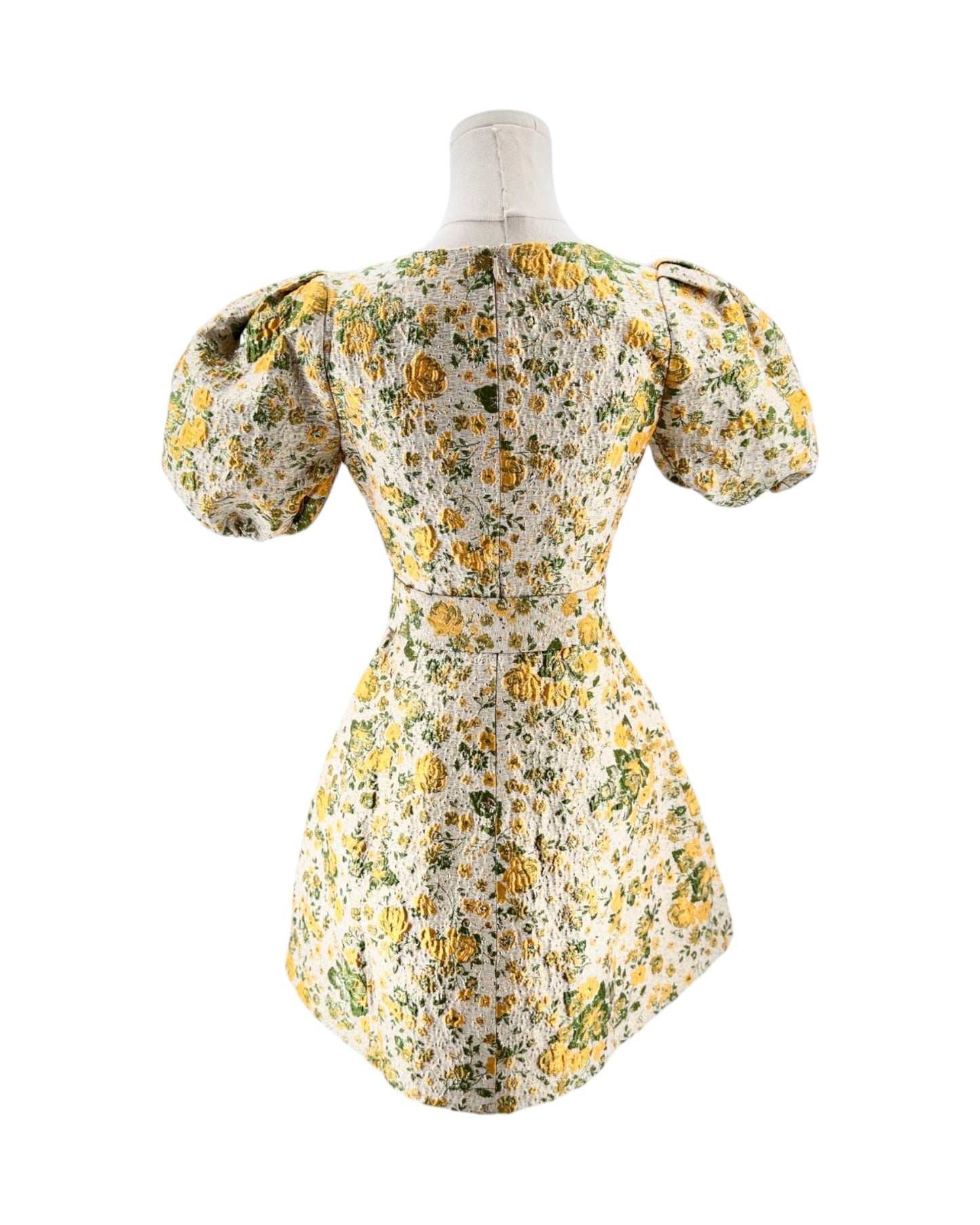 Floral dress on a mannequin against a white background