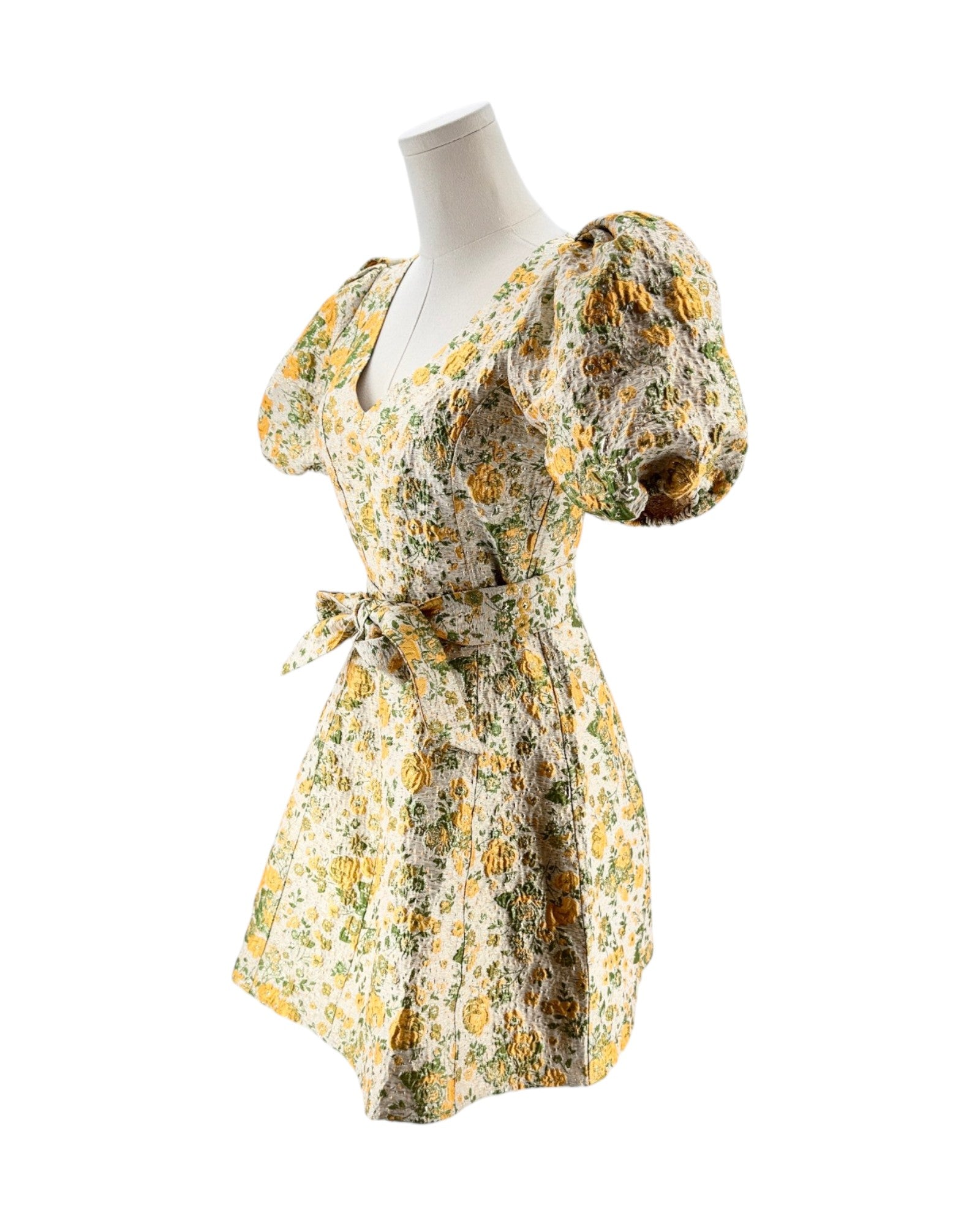Floral dress on a mannequin against a white background