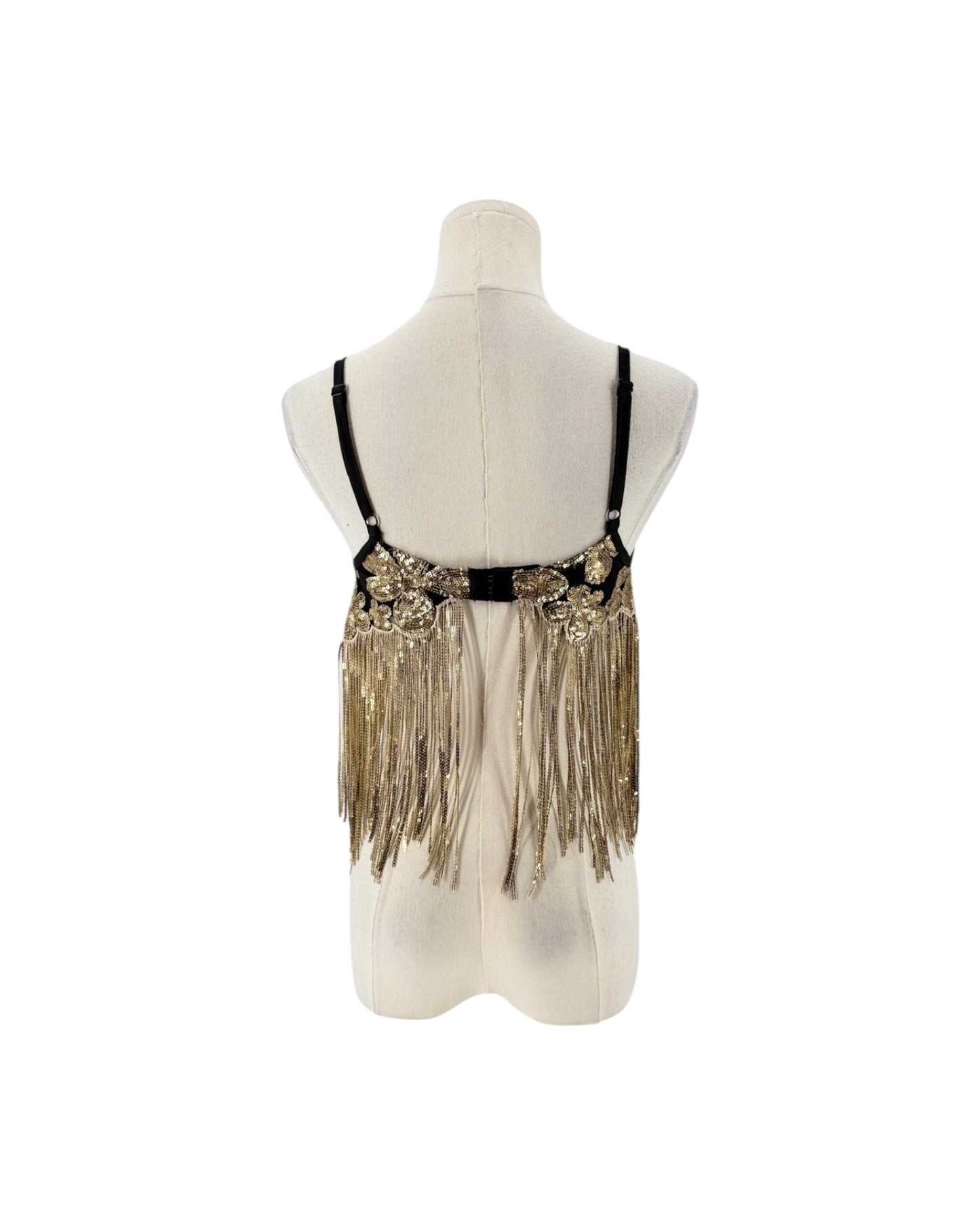A black and gold sequined belly dance hip scarf with long fringe, displayed on a cream-colored mannequin torso against a white background.