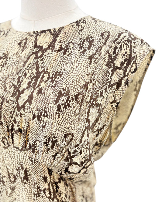 Snakeskin patterned dress on a mannequin against a white background