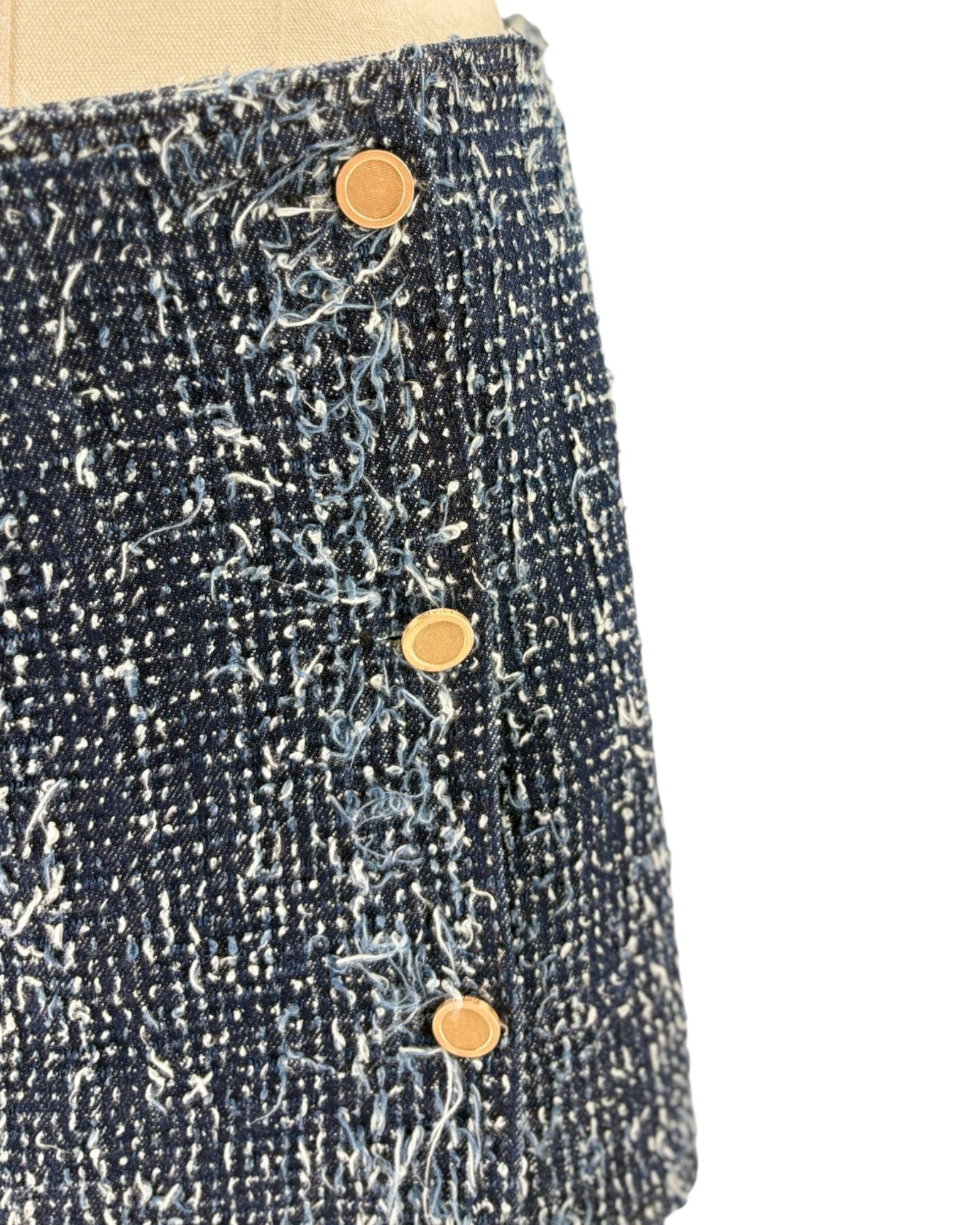 Close-up of a textured fabric with buttons on a white background