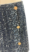 Close-up of a textured fabric with buttons on a white background