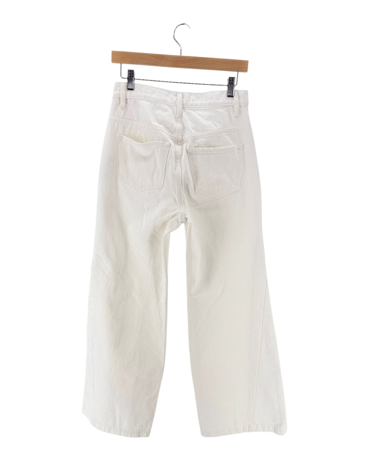 Off-white wide-leg cropped pants hanging from a wooden hanger against a plain white background.