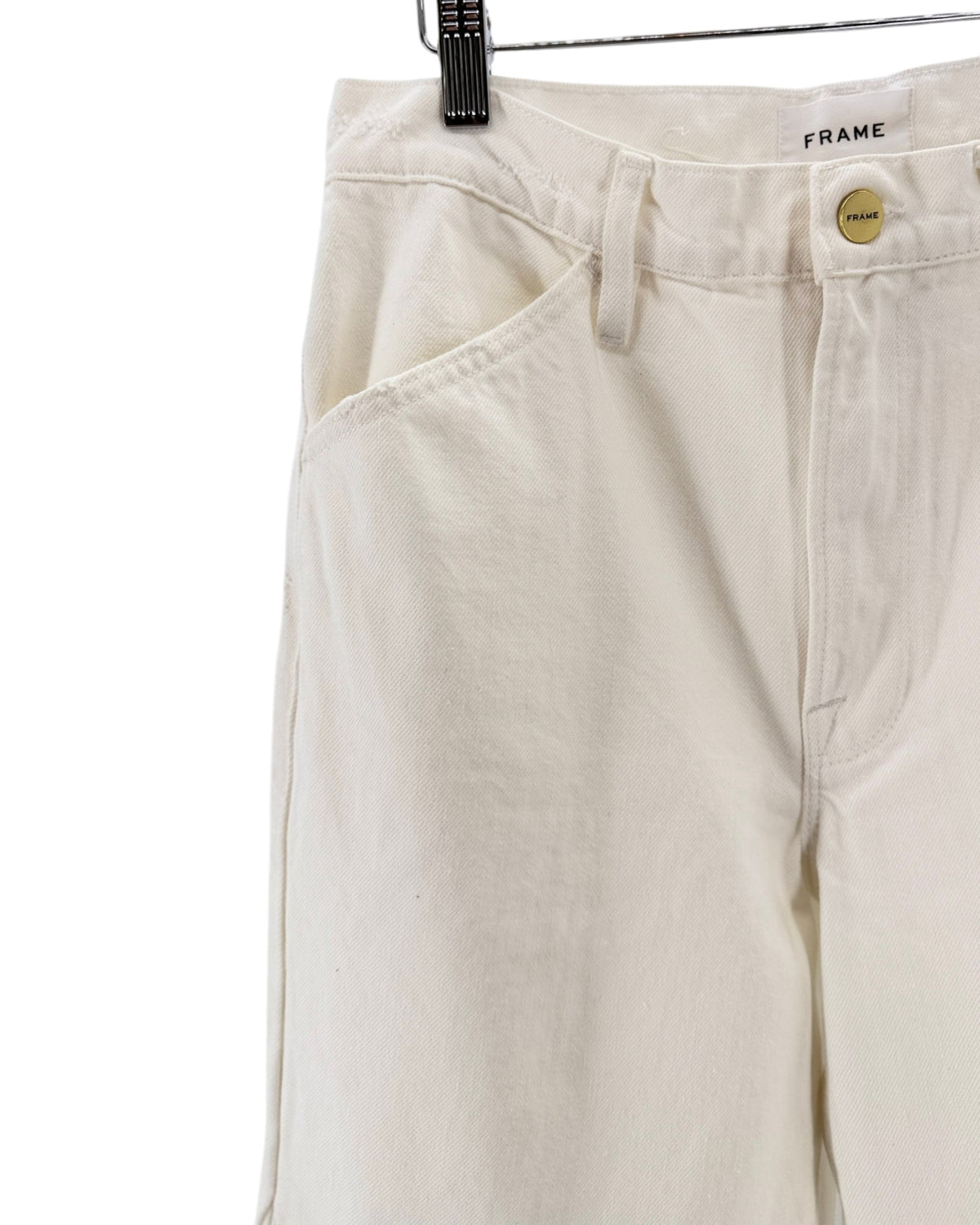 Off-white wide-leg cropped pants hanging from a wooden hanger against a plain white background.