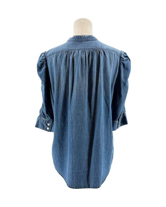 Blue denim shirt on a mannequin against a white background