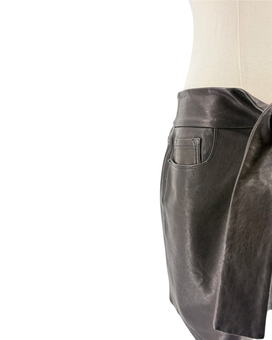 Black leather skirt on a mannequin against a white background