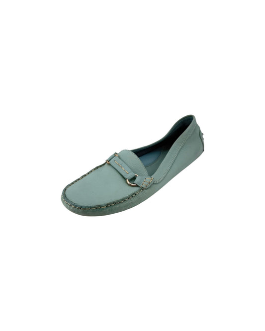 A light blue-green leather penny loafer with gold-tone hardware, shown from a top-down view on a white background.
