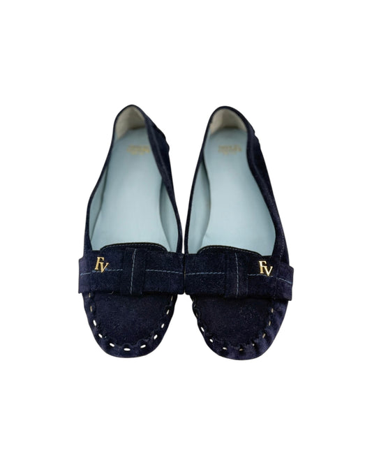 A pair of navy blue suede loafers with a old FV detail on a white background