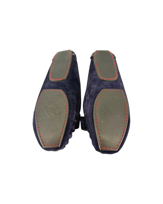 A pair of navy blue loafer soles on a white backgorund