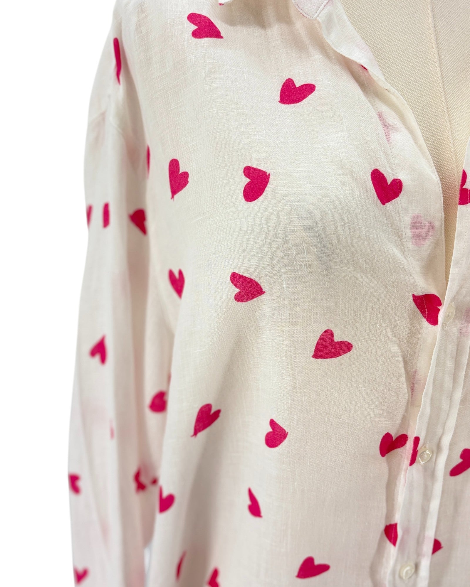 White shirt dress with pink heart patterns on a white background