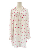 White shirt dress with pink heart patterns on a white background