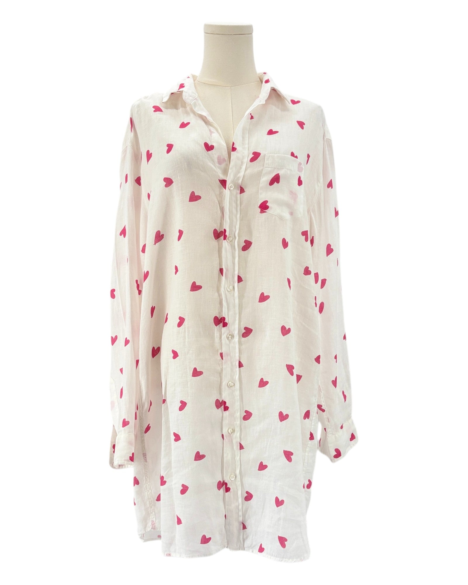 White shirt dress with pink heart patterns on a white background