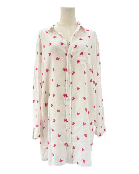 White shirt dress with pink heart patterns on a white background