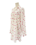 xWhite shirt dress with pink heart patterns on a white background
