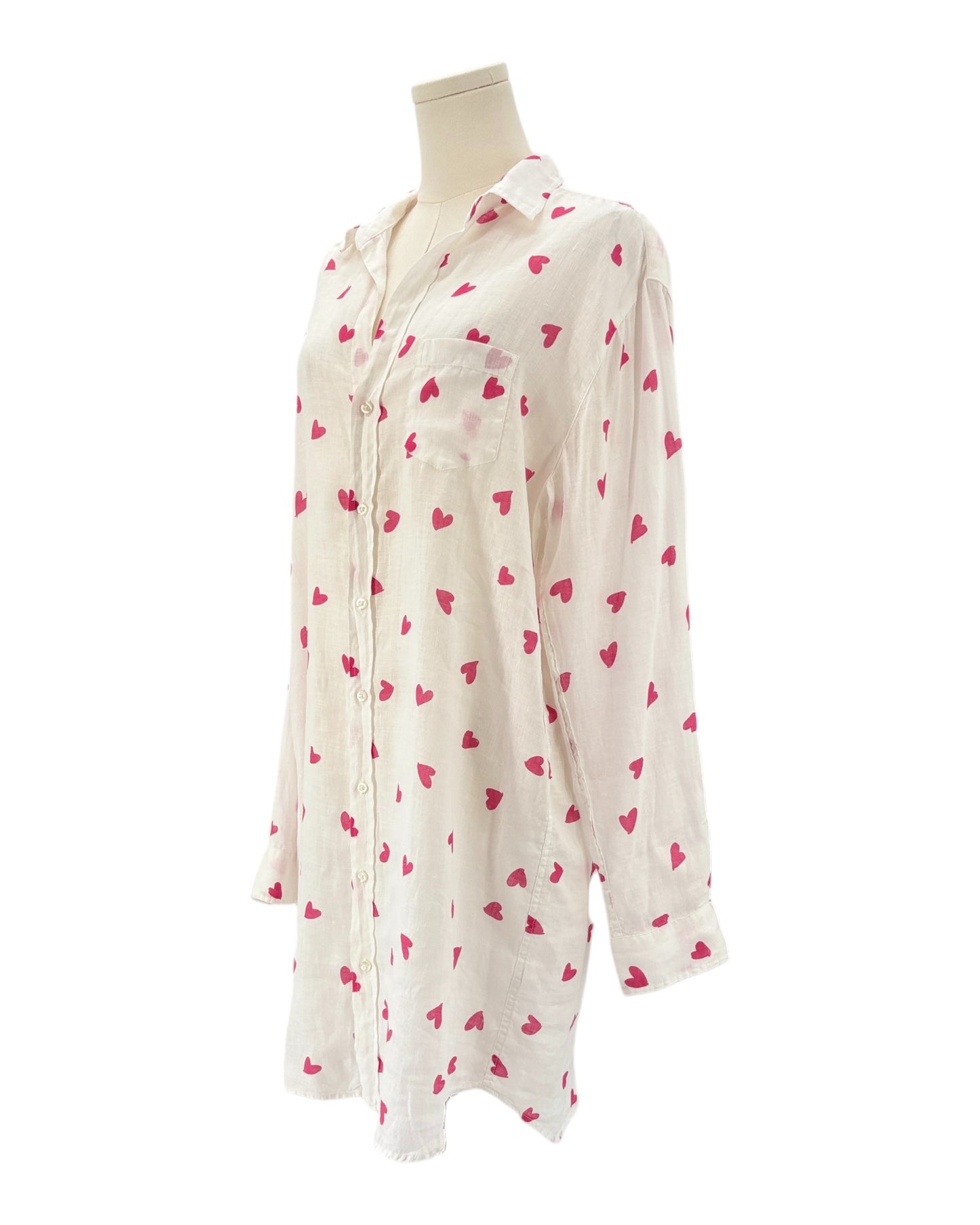 xWhite shirt dress with pink heart patterns on a white background