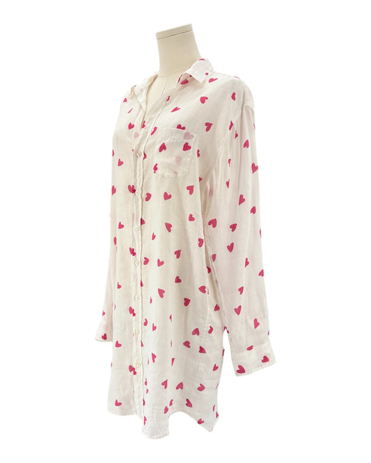 xWhite shirt dress with pink heart patterns on a white background