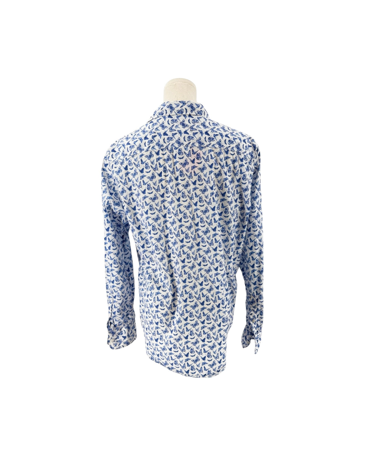A long-sleeve button-up shirt displayed on a mannequin torso, featuring an all-over repeating blue and white buttefly pattern.