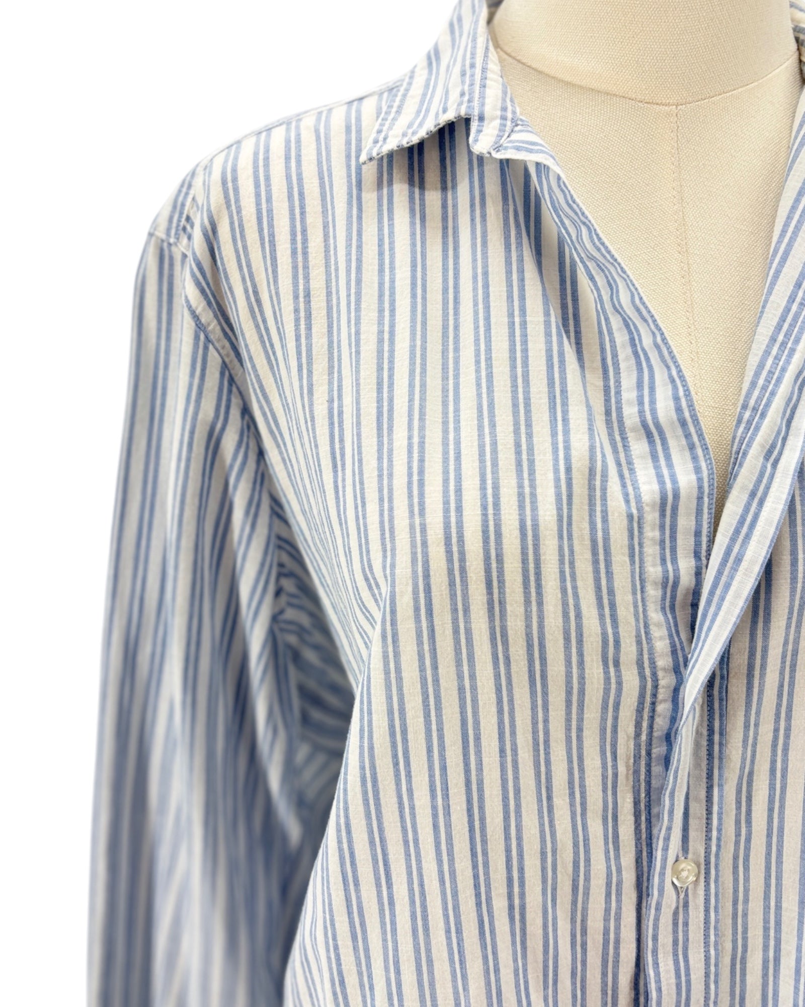 Striped shirt on a mannequin against a white background