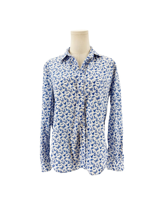 A long-sleeve button-up shirt with a blue and white butterfly pattern, displayed on a beige mannequin torso against a plain white background.