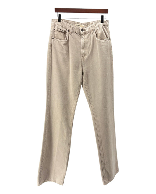 Beige pants on a hanger against a white background
