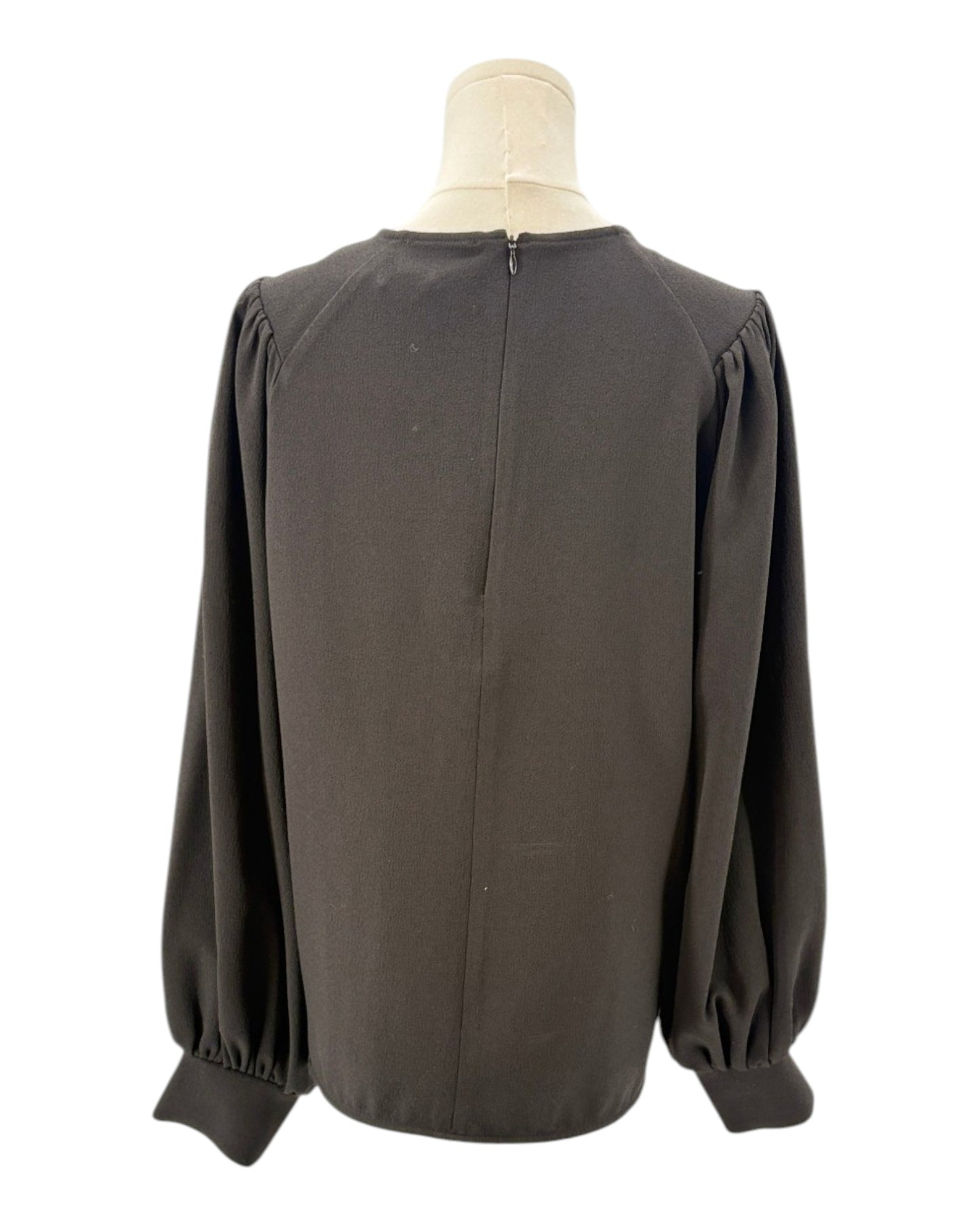 Ganni black blouse on a mannequin with a white background