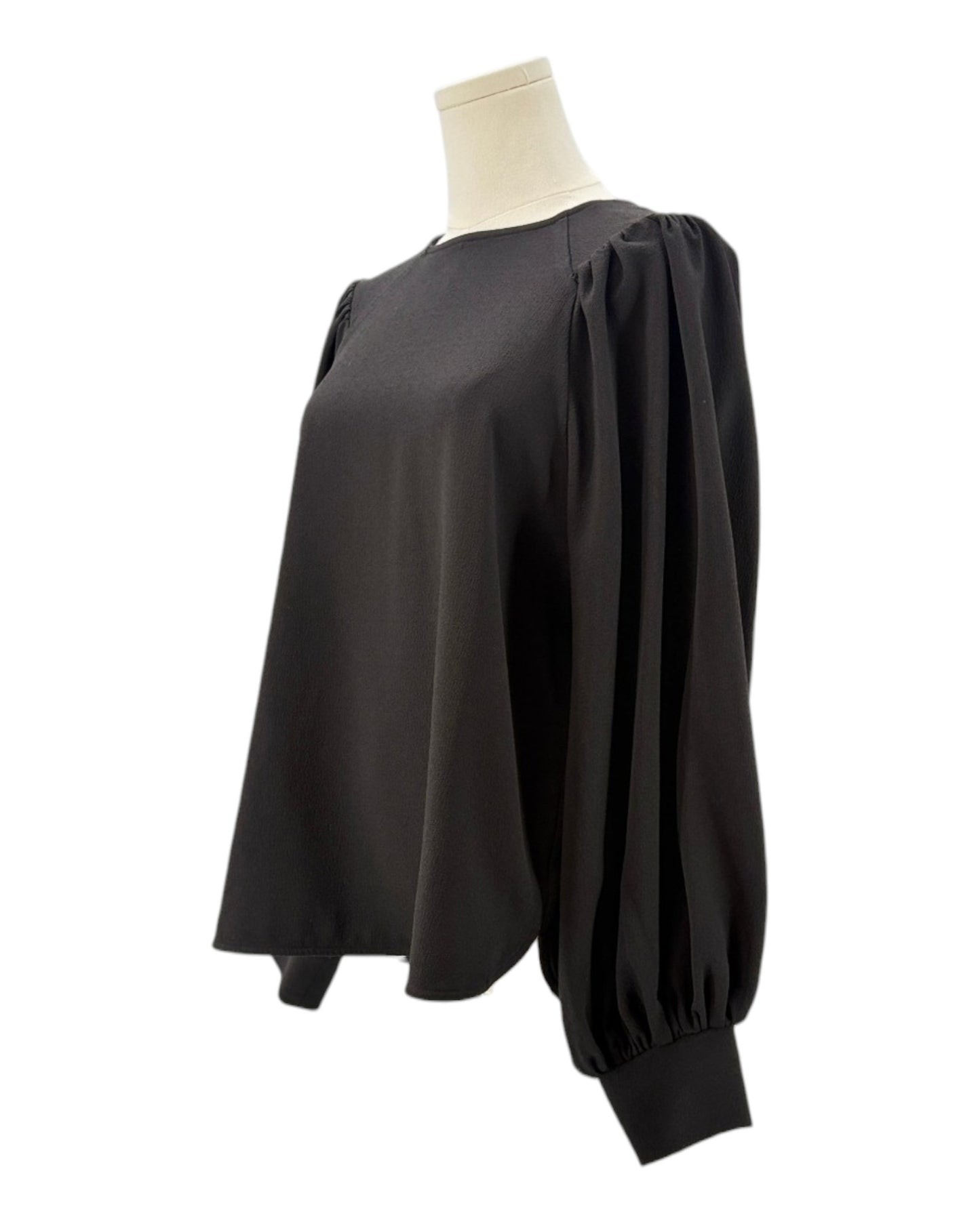 Ganni black blouse on a mannequin with a white background