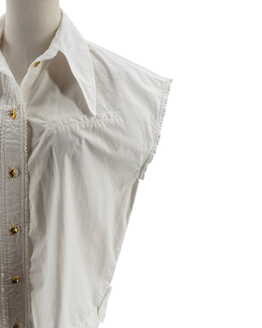 White sleeveless shirt on a mannequin with gold buttons against a white background