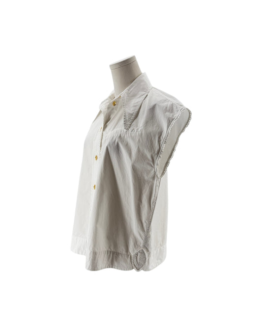 White sleeveless blouse on a mannequin against a white background