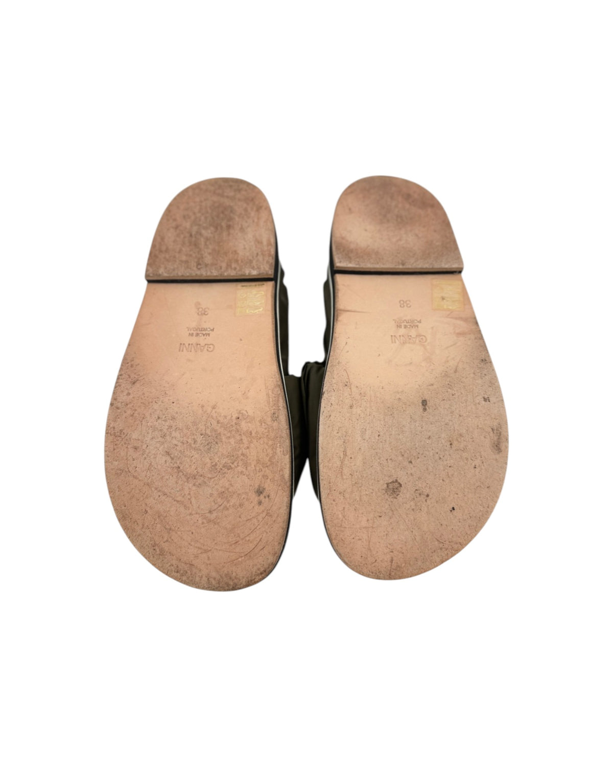 Leather shoe soles that say GANNI on a white background