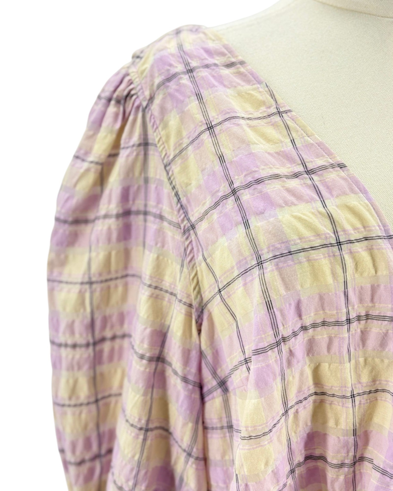 Plaid fabric with purple and yellow colors on a mannequin.