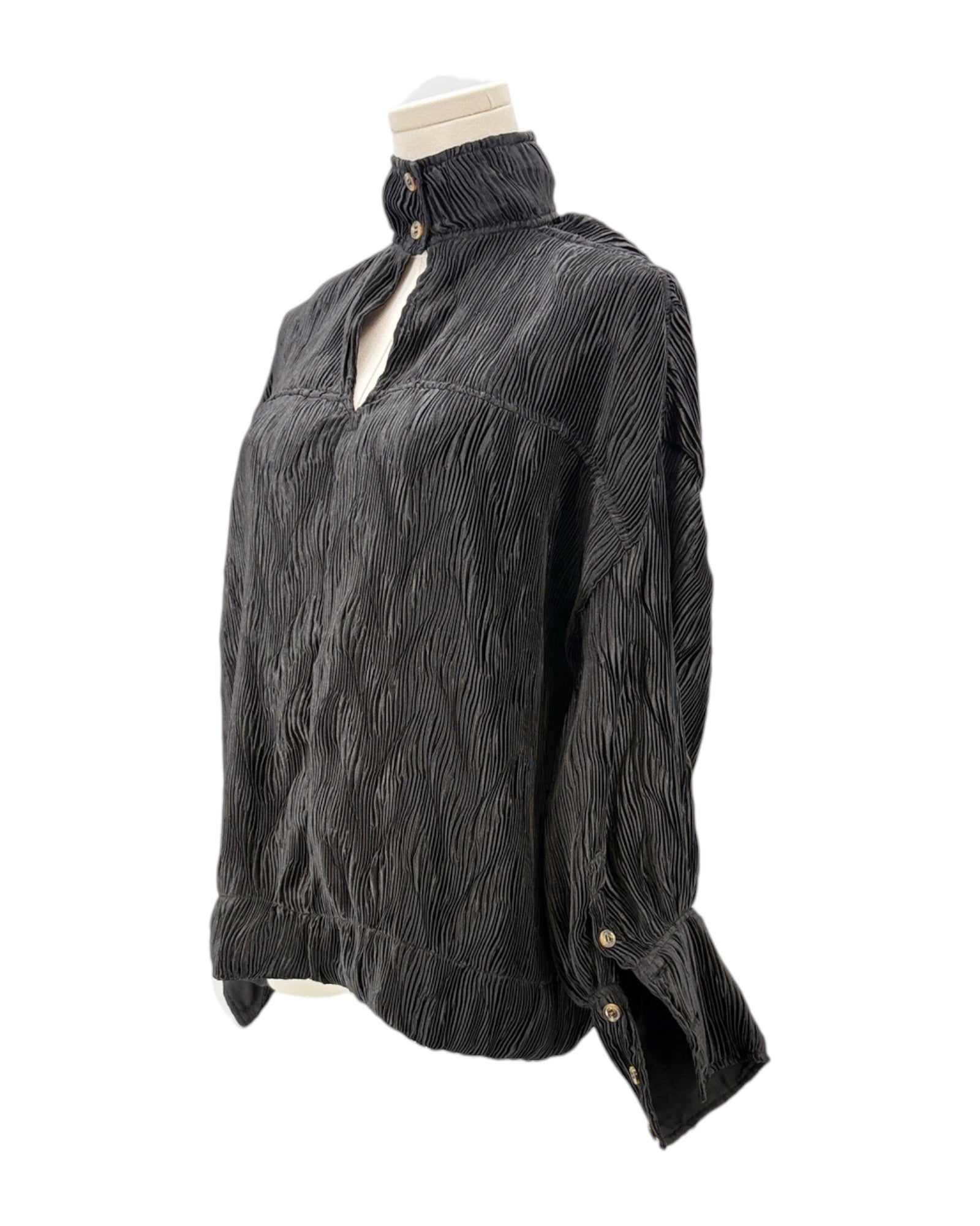 Black textured blouse on a mannequin against a white background