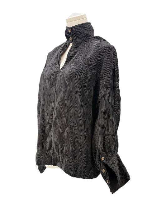 Black textured blouse on a mannequin against a white background
