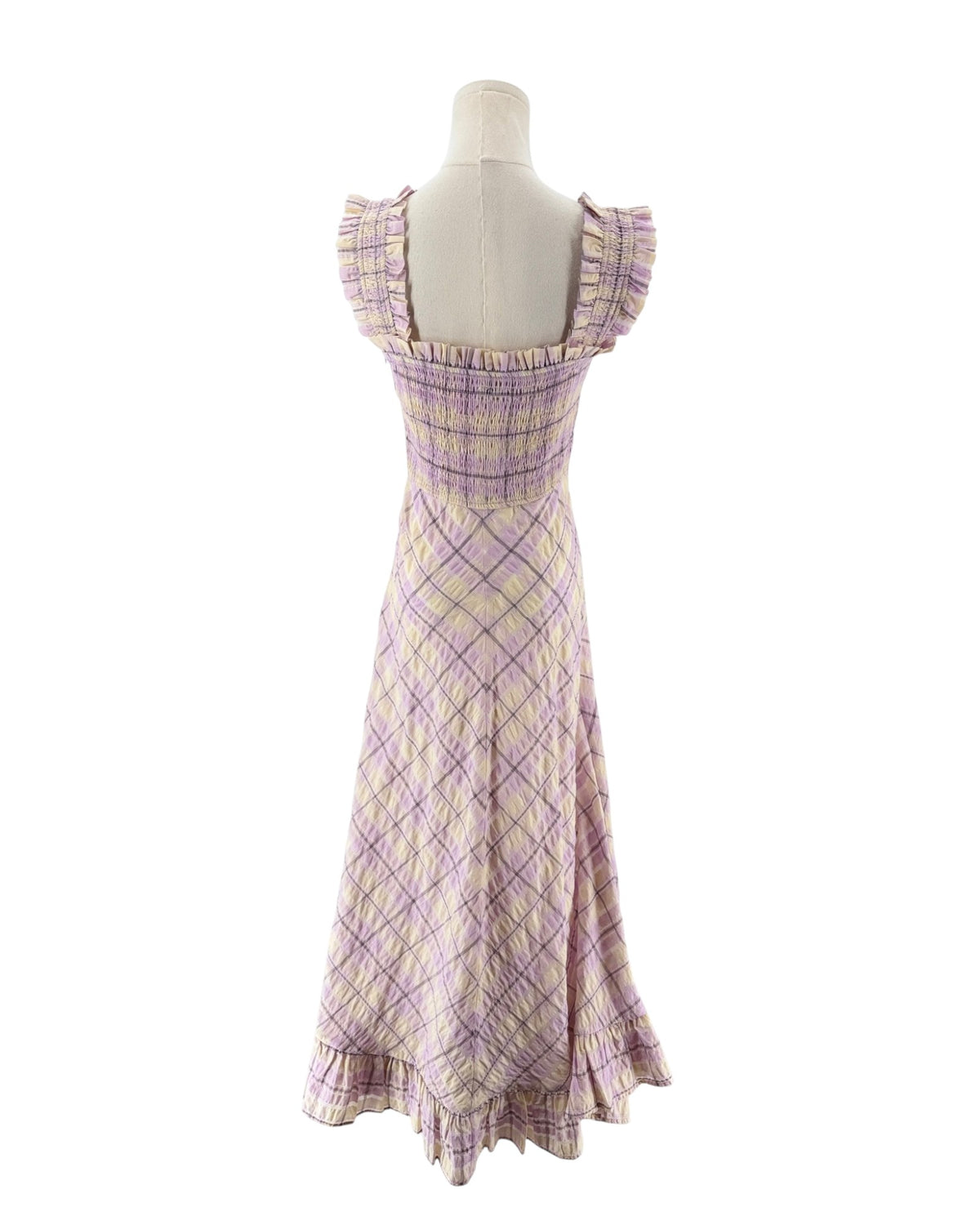 A sleeveless, smocked maxi dress with a purple and beige plaid pattern, displayed on a mannequin against a white background.