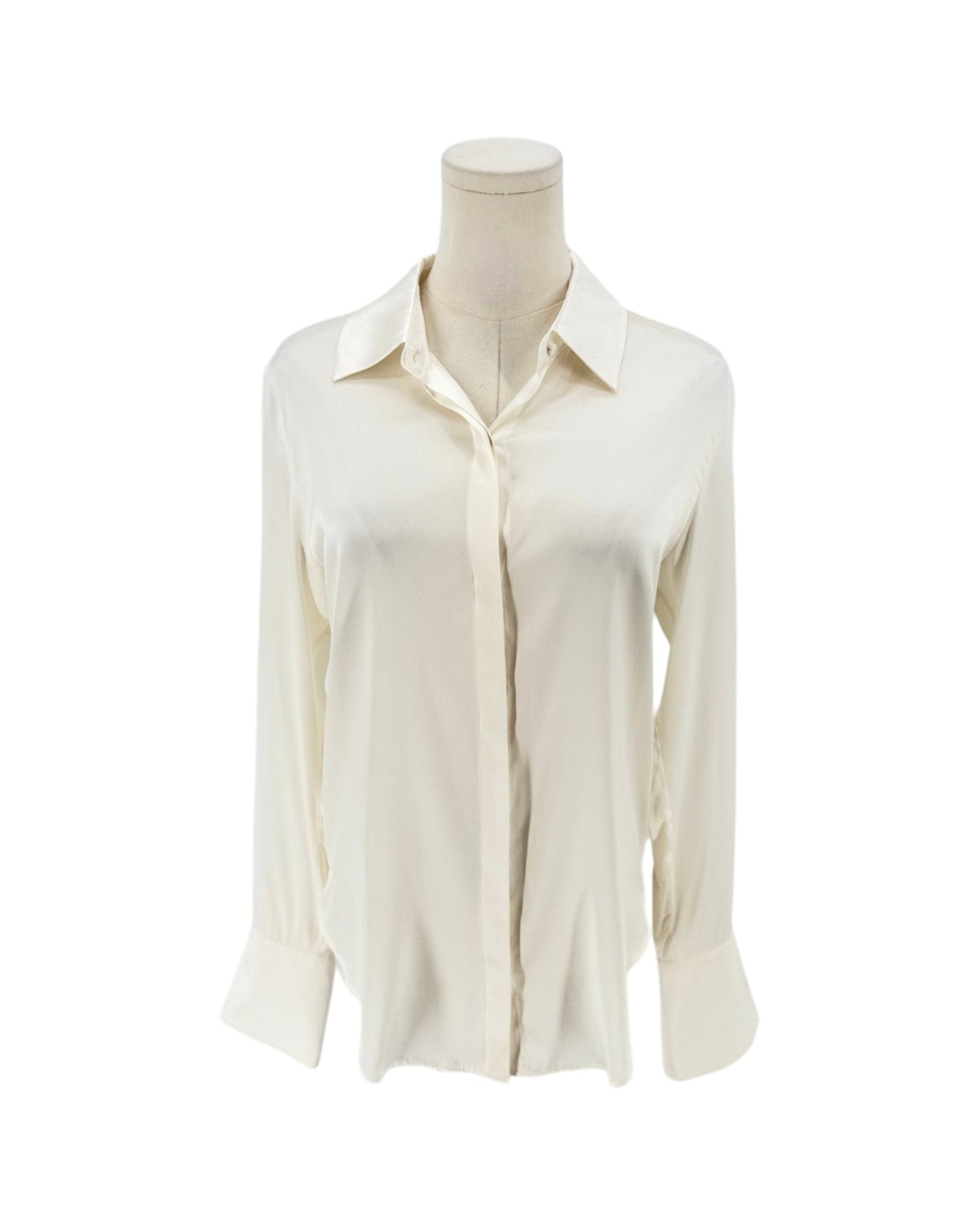 An off-white long-sleeve button-up shirt displayed on a cream mannequin torso against a plain white background.