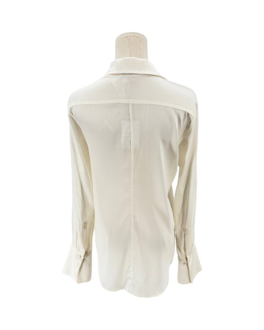 An off-white long-sleeve button-down shirt shown from the back on a dress form mannequin against a plain white background.