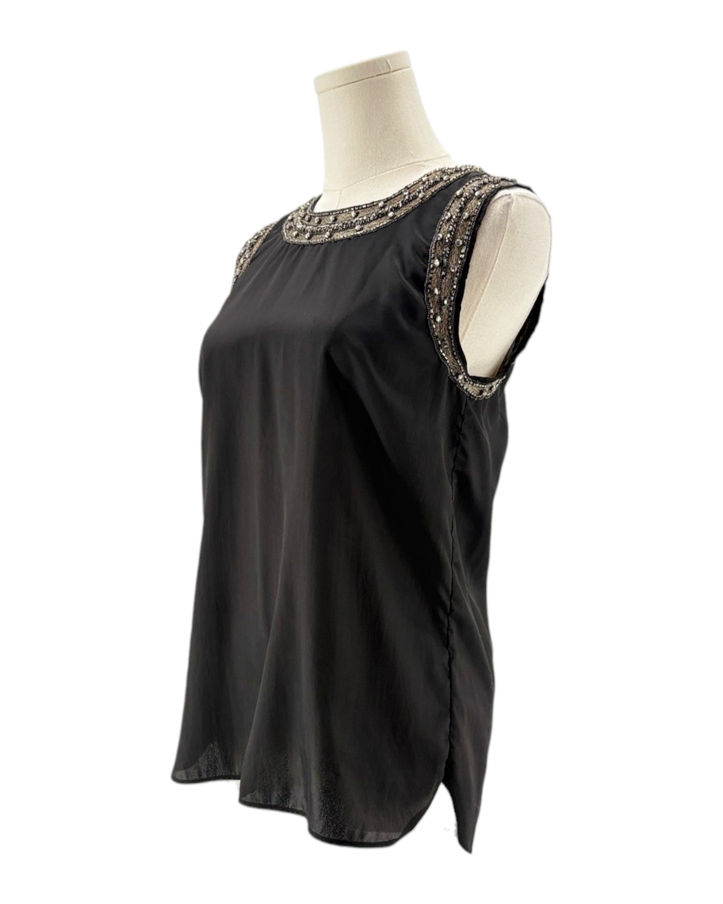 Black sleeveless top with embellished neckline on a mannequin against a white background