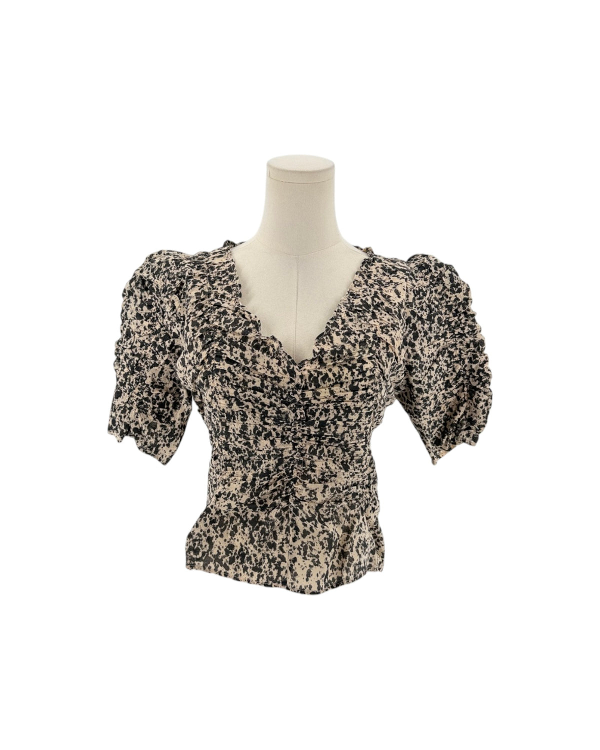 A short-sleeve V-neck blouse with puff sleeves, featuring a black and beige abstract floral print, displayed on a mannequin torso against a white background.