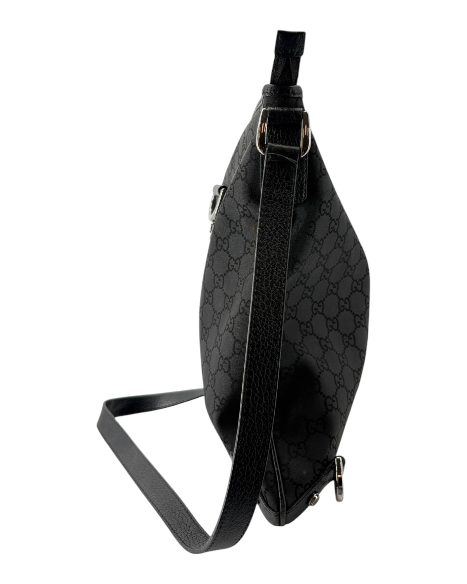 Black patterned crossbody bag on a white background