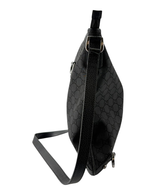 Black patterned crossbody bag on a white background