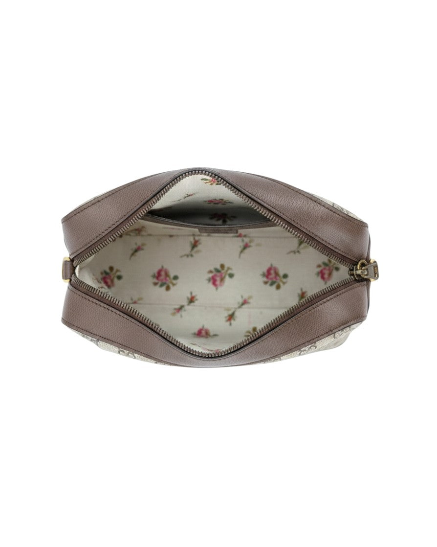 Small leather handbag with a floral interior on a white background