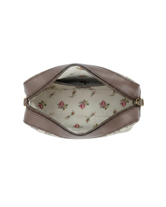 Small leather handbag with a floral interior on a white background