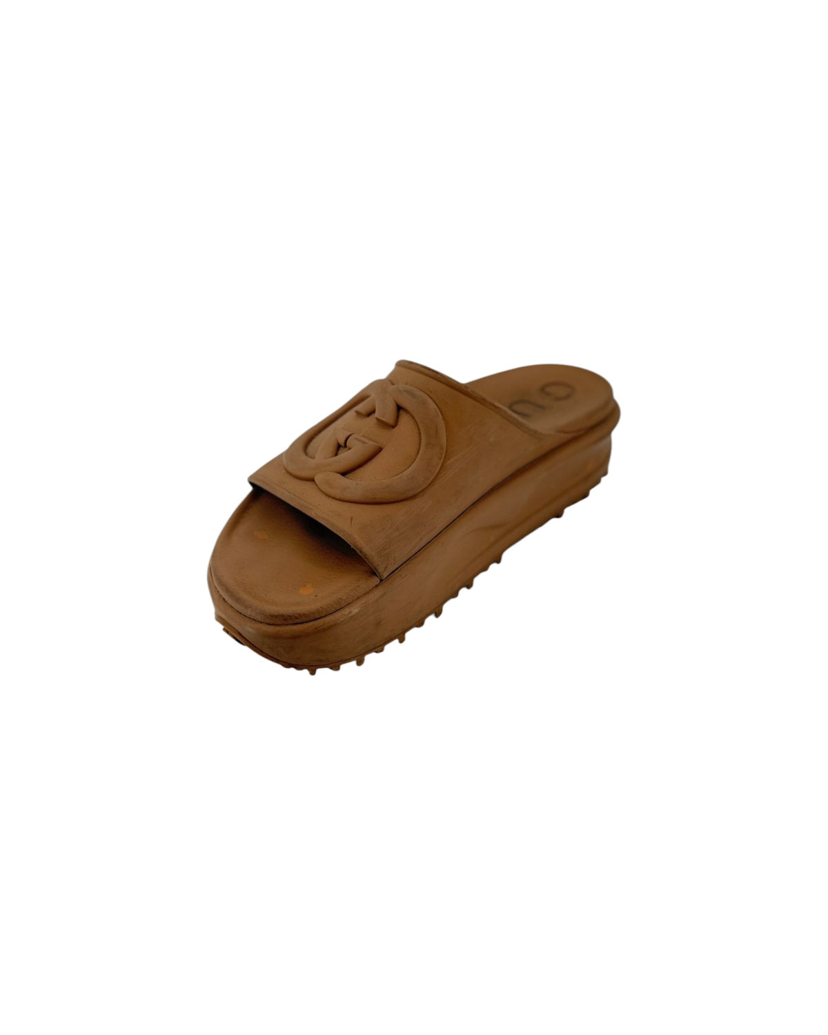 A single brown platform slide sandal with a large embossed circular G logo on the strap, shown against a plain white background.