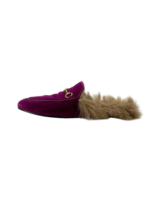 Plum colored laofers with fur accents on a white background