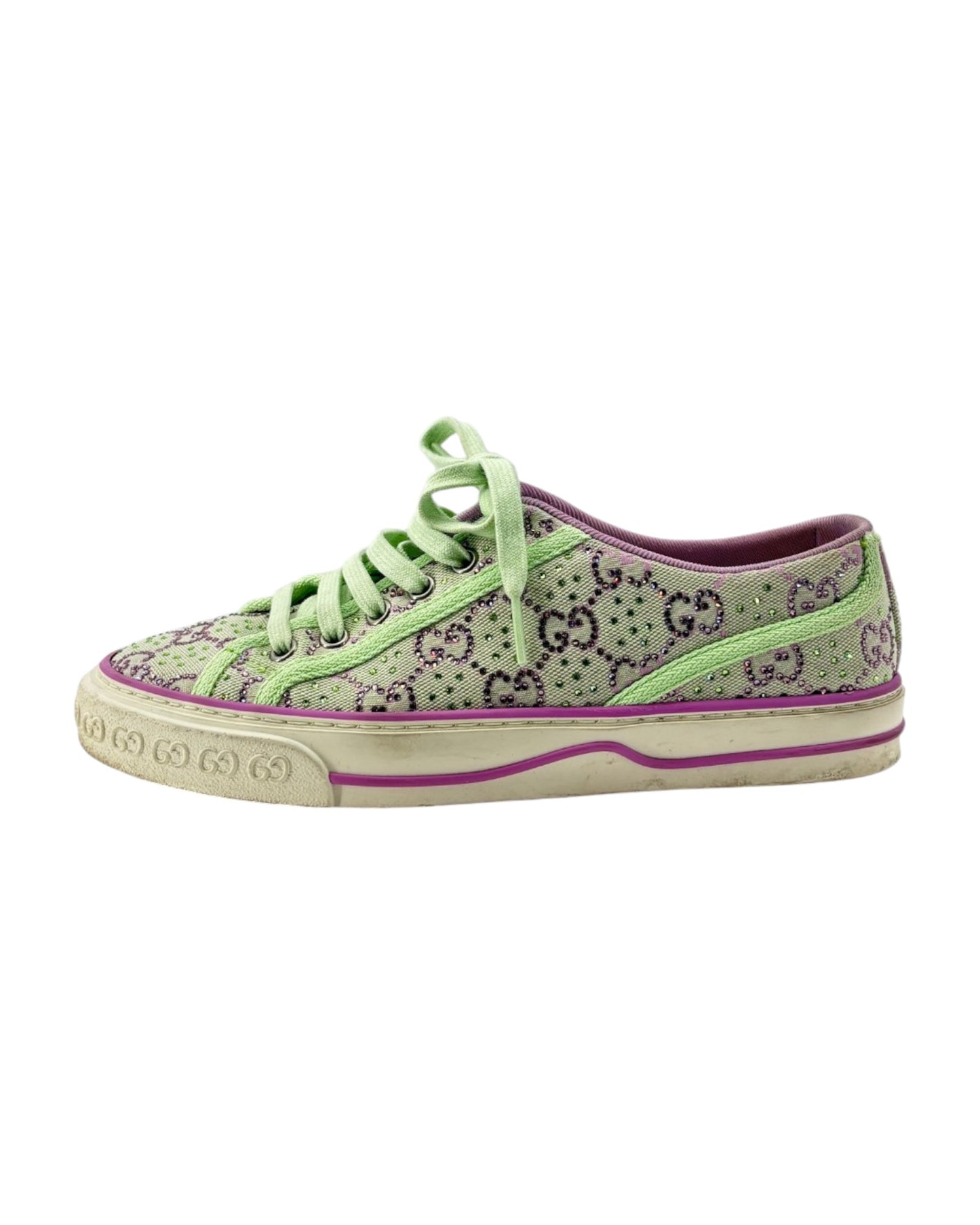 Green sneaker with G pattern and visible brand logo on a white background
