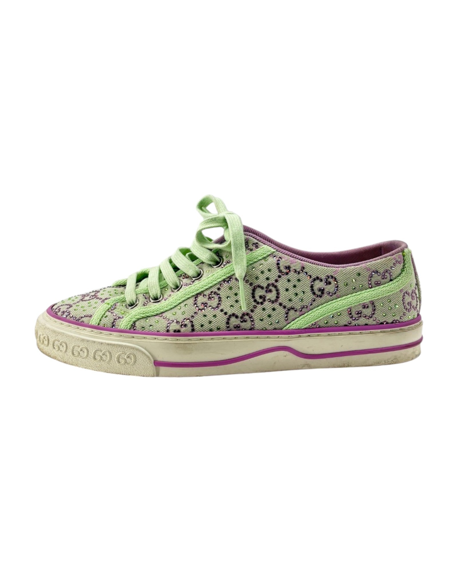 Green sneaker with G pattern and visible brand logo on a white background