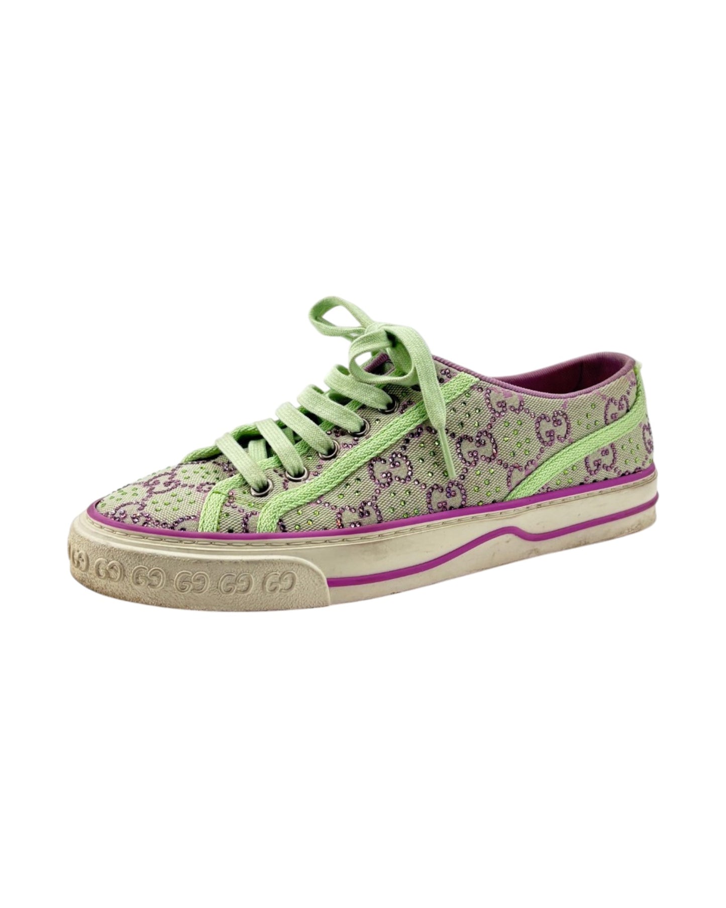 Green slip-on shoe with a thick white sole on a light gray background