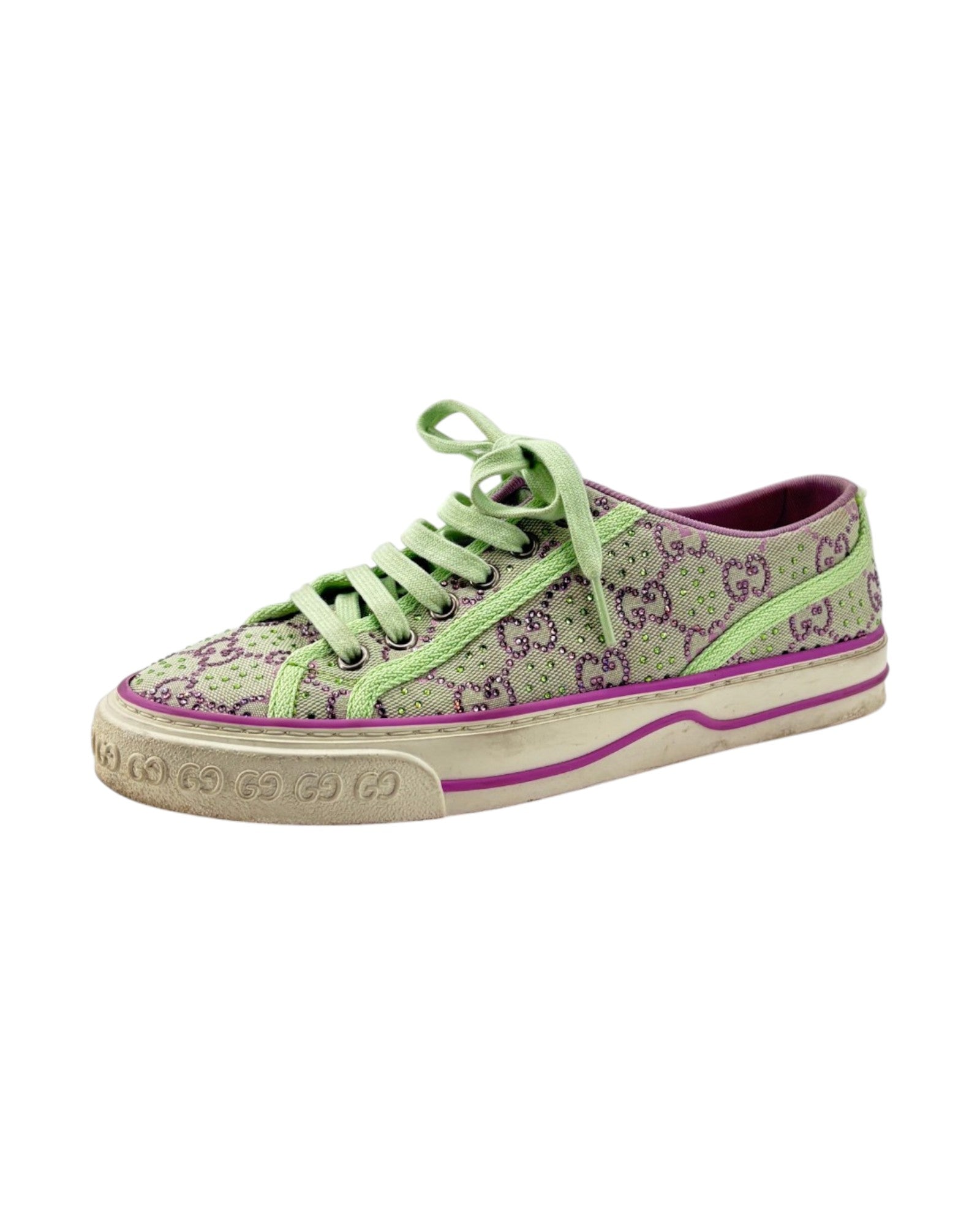 Green slip-on shoe with a thick white sole on a light gray background