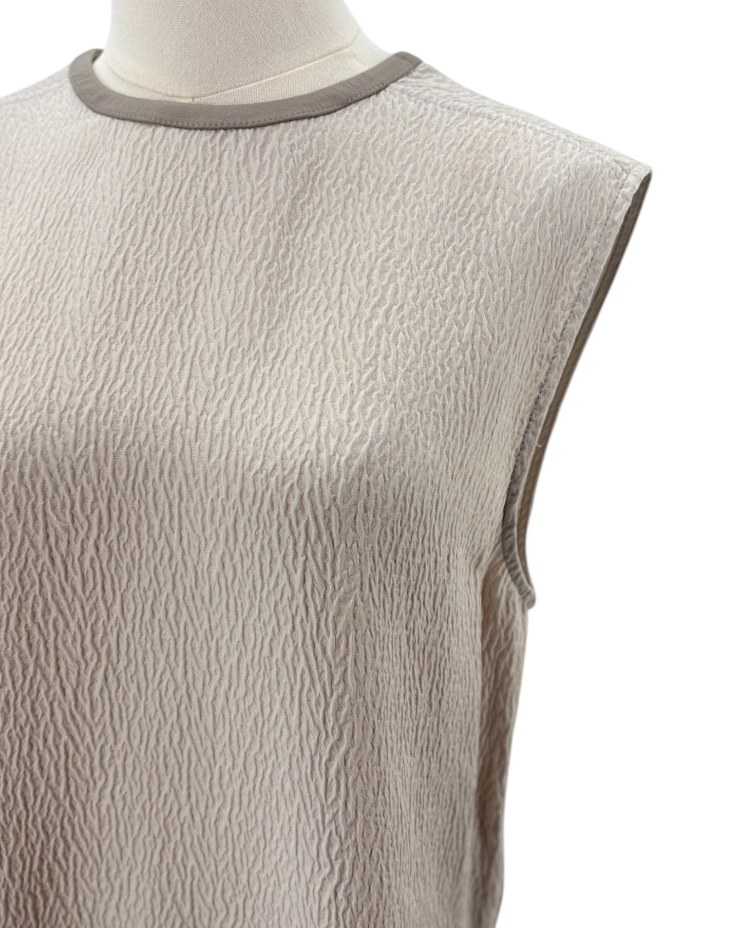 Helmut Lang beige sleeveless top on a mannequin with a white background